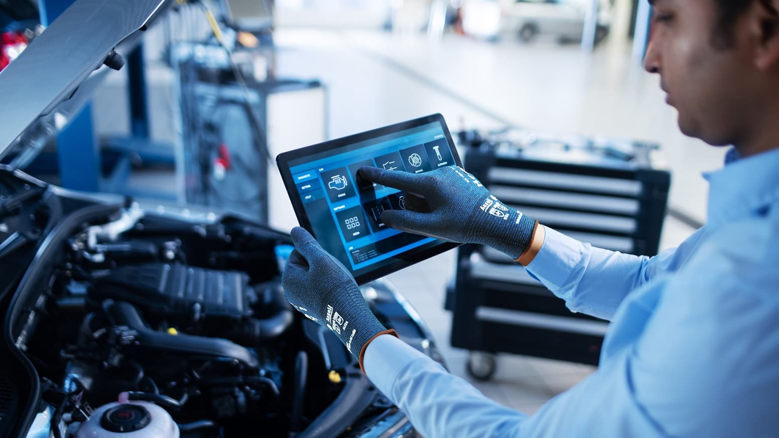 Mechanic Uses a Tablet inspect Car
