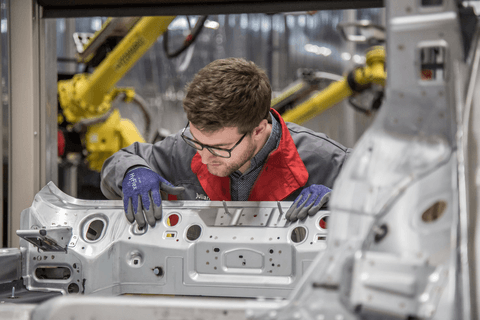 Worker wearing HyFlex 11-561 mechanical gloves, performing maintenance on machinery