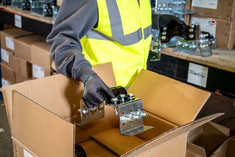 Worker in warehouse handling tasks with HyFlex 11-844 gloves for grip, safety, and dexterity.