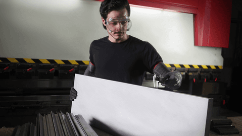 Operator wearing HyFlex® 11-281 sleeves handles a panel, ensuring safe grip and careful positioning during transport