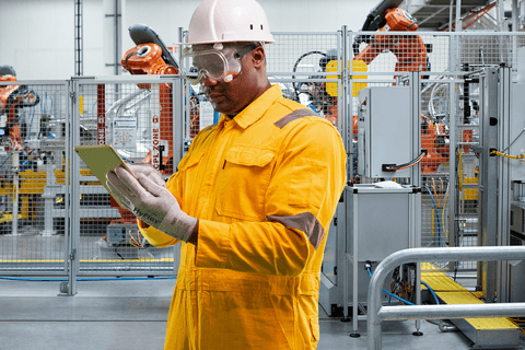 Worker operates in an industrial setting wearing HyFlex® 11-755 mechanical gloves, ensuring safe and precise handling