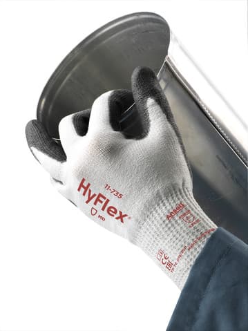 Hand wearing HyFlex 11-735 glove, holding a steel pipe