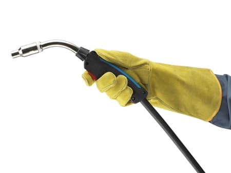 Operator wearing ActivArmr® 43-216 mechanical gloves grips a welding torch, preparing for precision work in metal fabrication