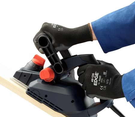 Hands wearing EDGE 48-126 mechanical gloves using an electric hand planer